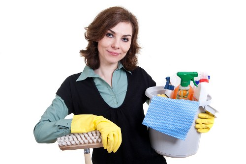 Staff member using protective gloves and footwear during carpet cleaning